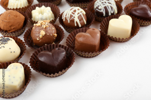 Delicious chocolate candies on white background