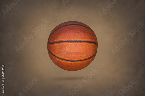 Old basketball on grunge texture background © ipopba