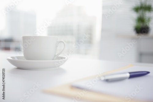 Coffee cup and saucer on desk