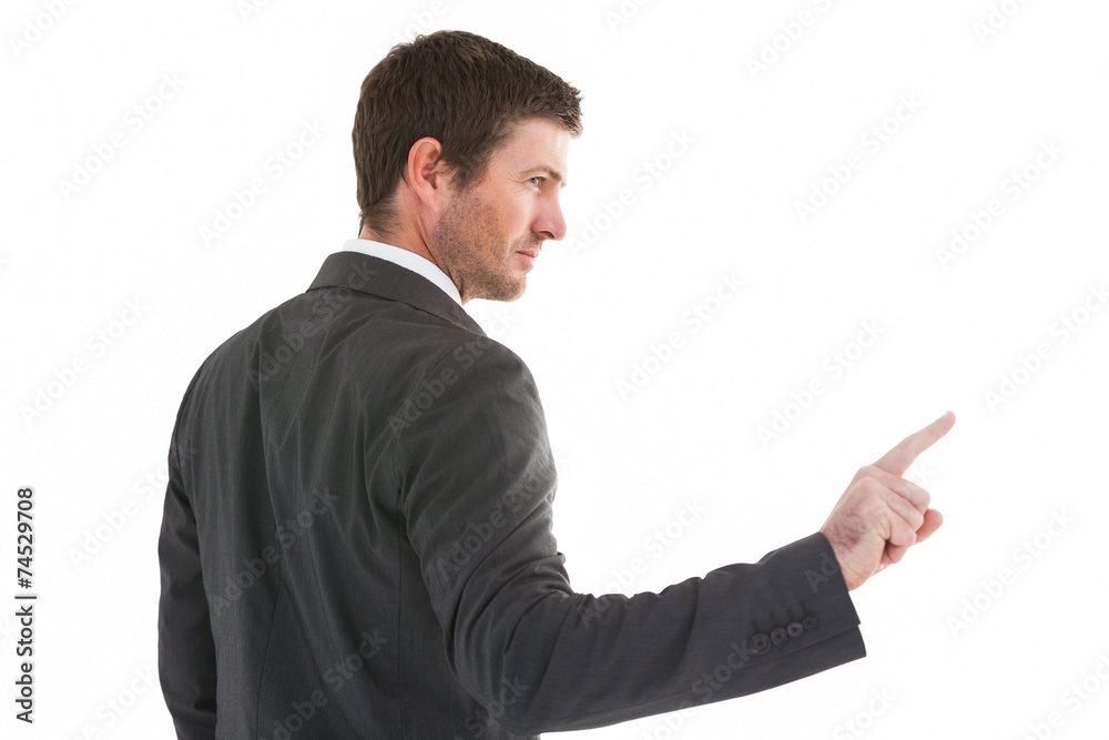 Serious businessman standing and pointing the finger Serious businessman standing and pointing the finger