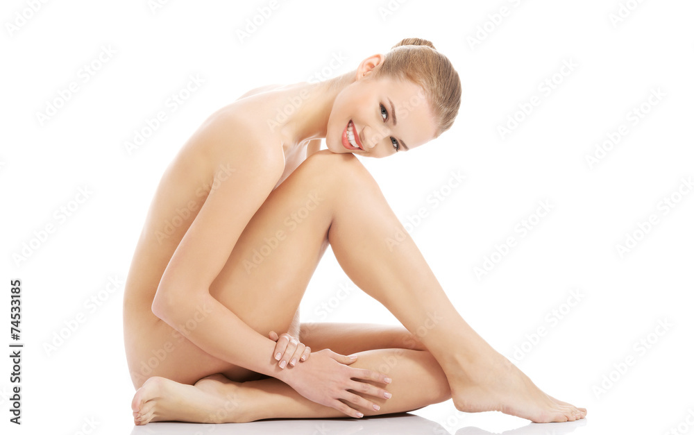 Fototapeta premium Side view nude woman sitting on the floor