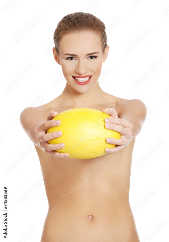 Happy nude woman holding yellow mango Stock Photo | Adobe Stock