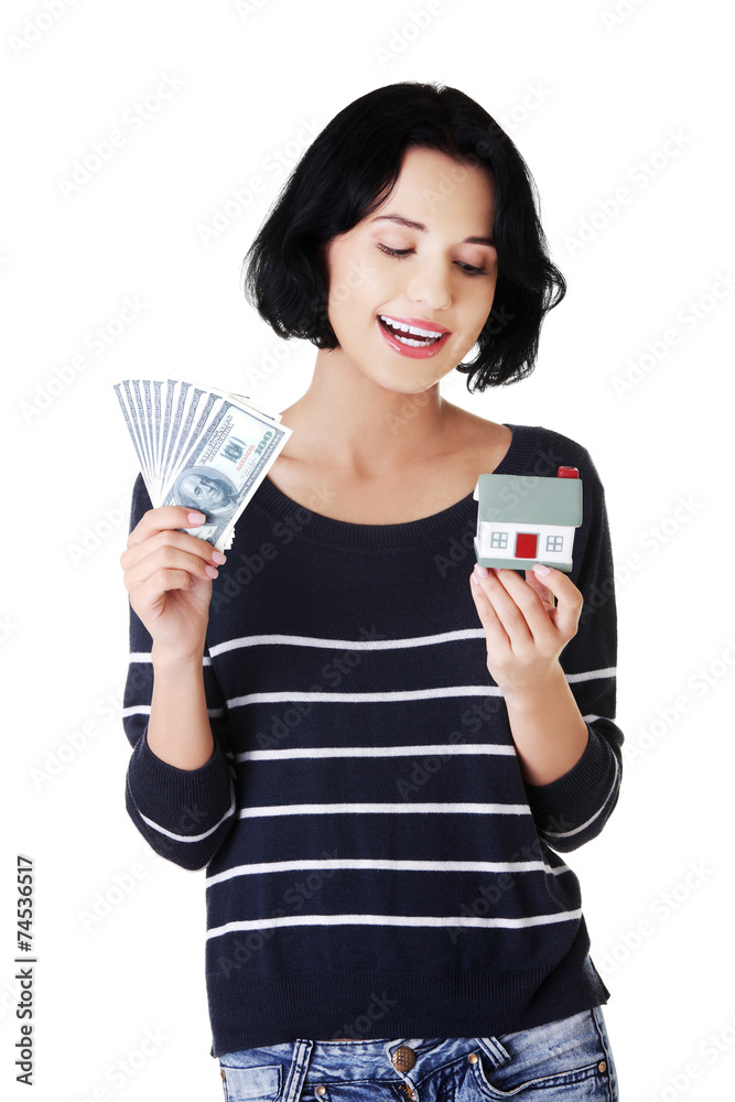 Happy woman holding a house model and dollar bills Happy woman holding a house model and dollar bills