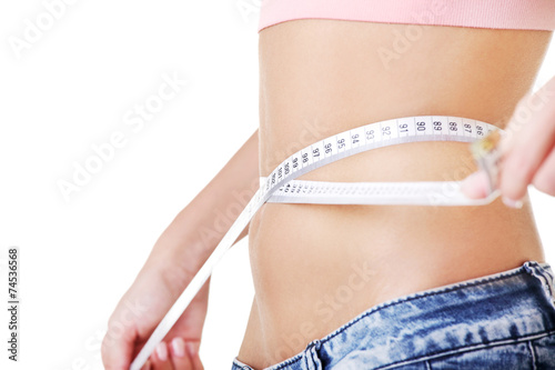Woman measuring her waistline