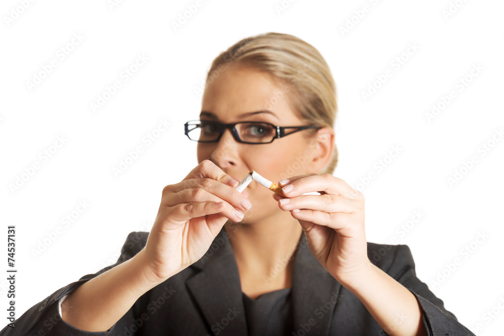 Woman breaking cigarette to stop smoking Woman breaking cigarette to stop smoking