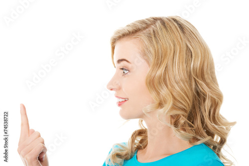 Side view of woman looking on her finger