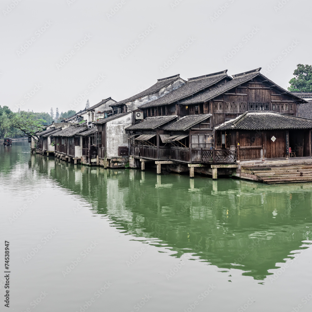 Chinese wood houses besides the river
