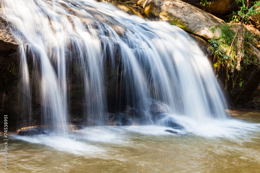 Scenic waterfall flowing on stone at Mae Sa waterfall Doi Suthep