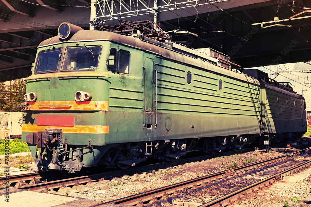 Green modern Russian locomotive with red stripes on cabin Green modern Russian locomotive with red stripes on cabin