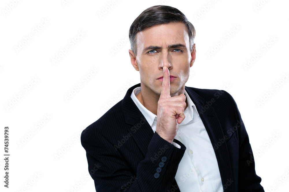 Businessman placing finger on lips saying shhh, be quiet! Businessman placing finger on lips saying shhh, be quiet!
