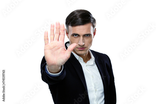 Confident buisnessman making stop gesture photo