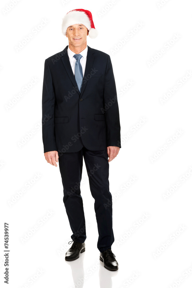 Mature businessman wearing santa hat Mature businessman wearing santa hat