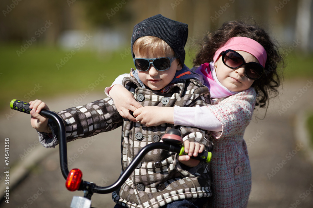 girl and boy riding on bicycle