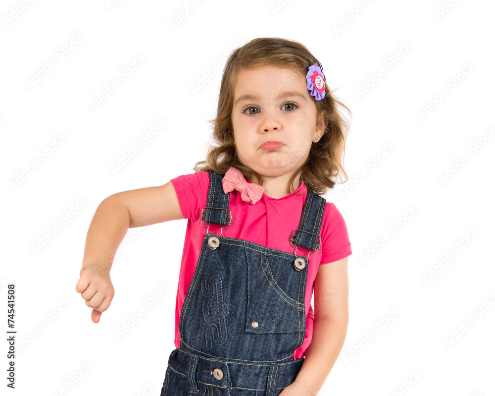 Kid doing a bad signal over white background Kid doing a bad signal over white background
