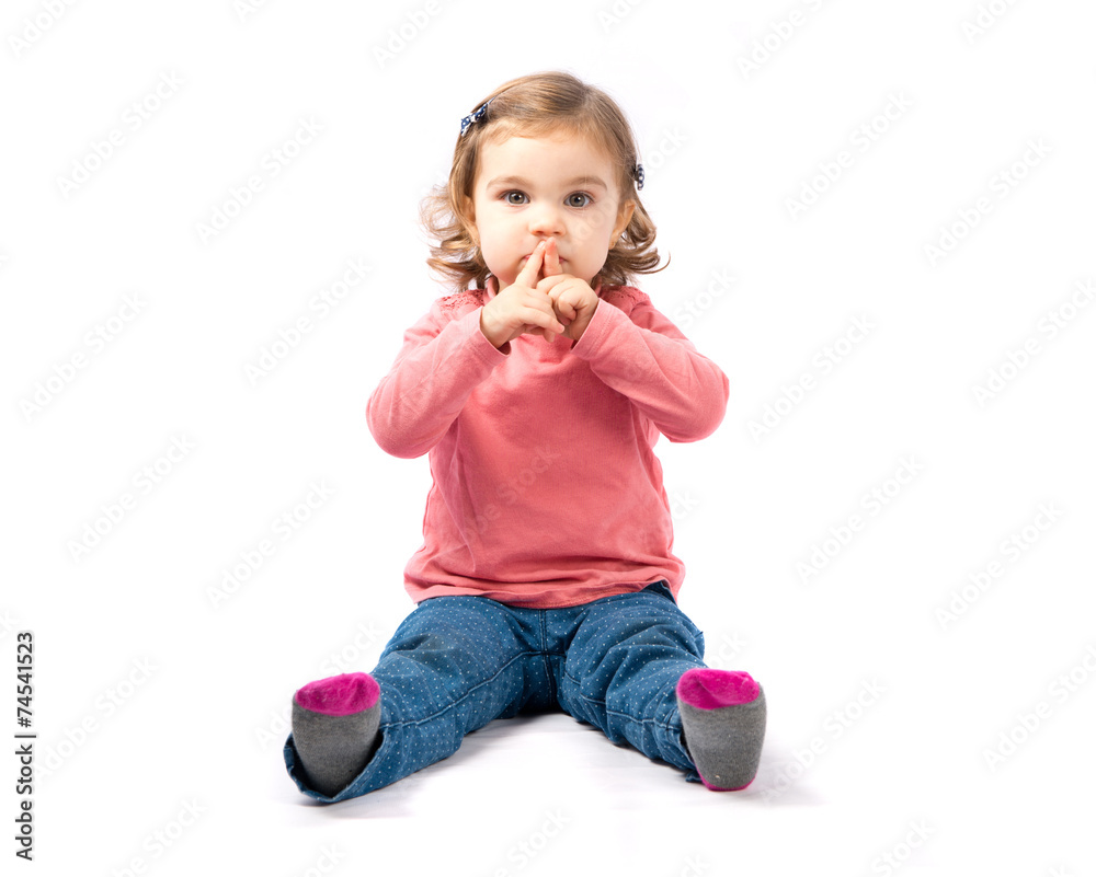 Cute girl doing silence gesture over white background Cute girl doing silence gesture over white background