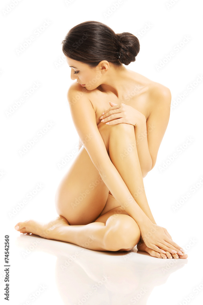 Nude woman sitting, looking through her shoulder Nude woman sitting, looking through her shoulder