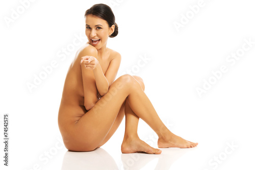 Side view of nude woman pointing on you