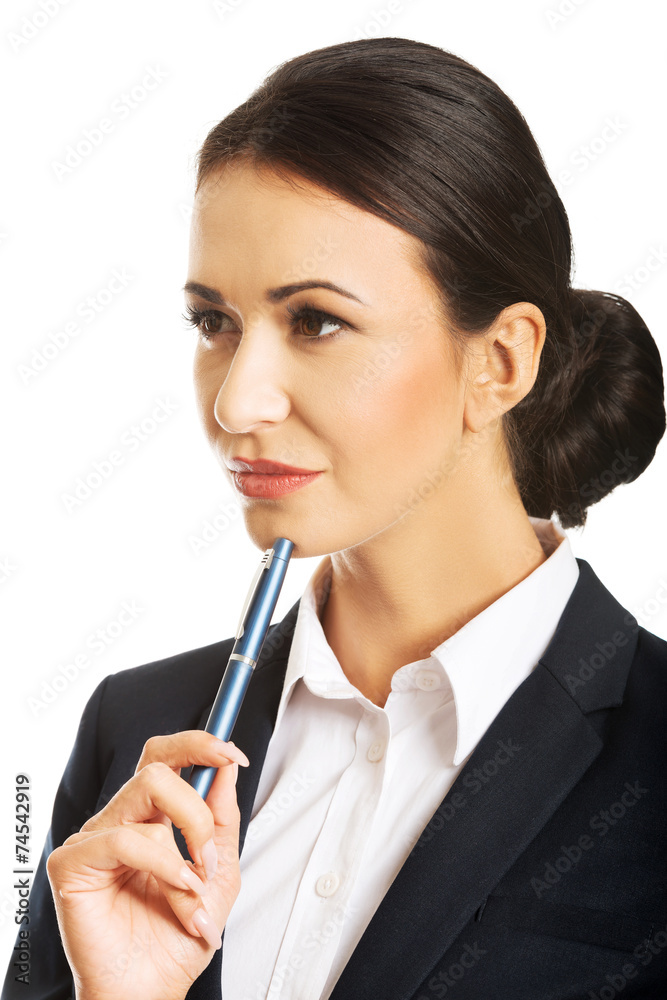 Portrait of thoughtful businesswoman holding a pen