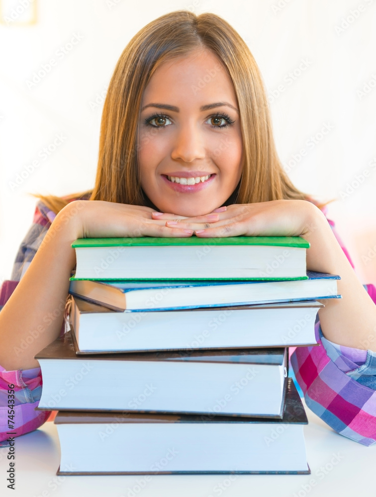 Smiling student with stack of books Smiling student with stack of books