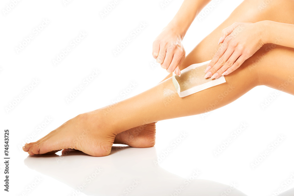 Close up on woman shaving her leg