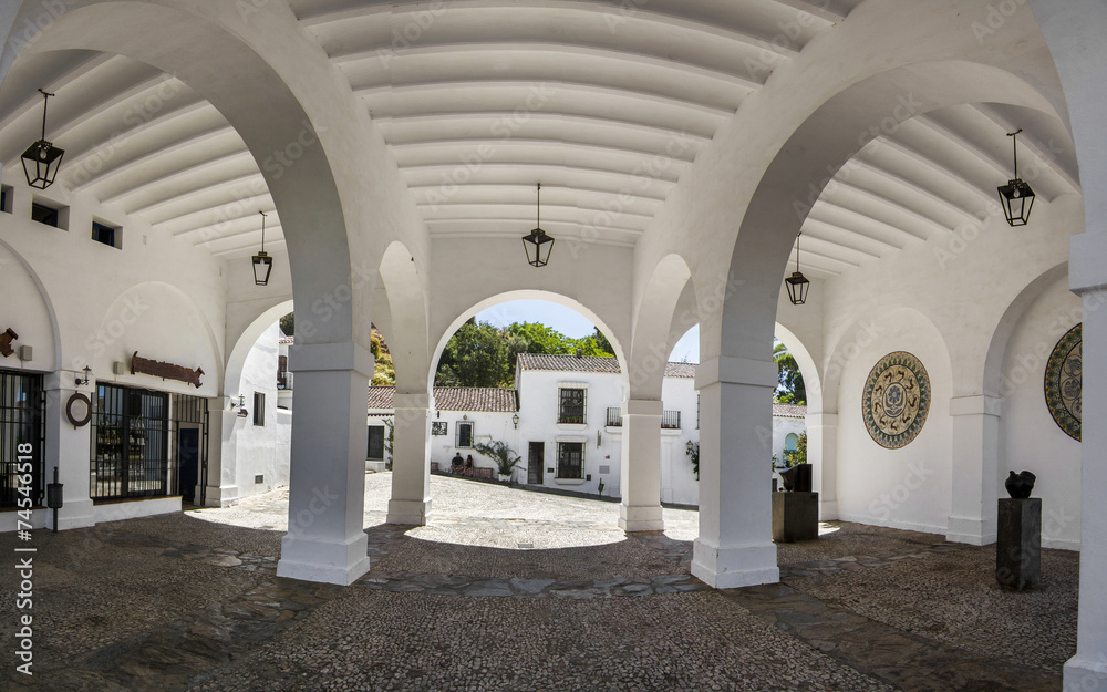 View of beautiful arcs of a building located in Aracena, Spain.