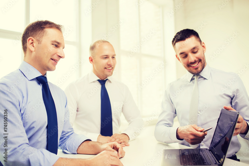 smiling businessmen having discussion in office smiling businessmen having discussion in office