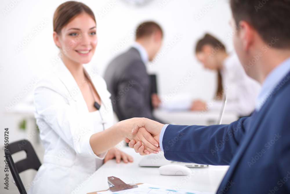 Business people shaking hands, finishing up a meeting Business people shaking hands, finishing up a meeting