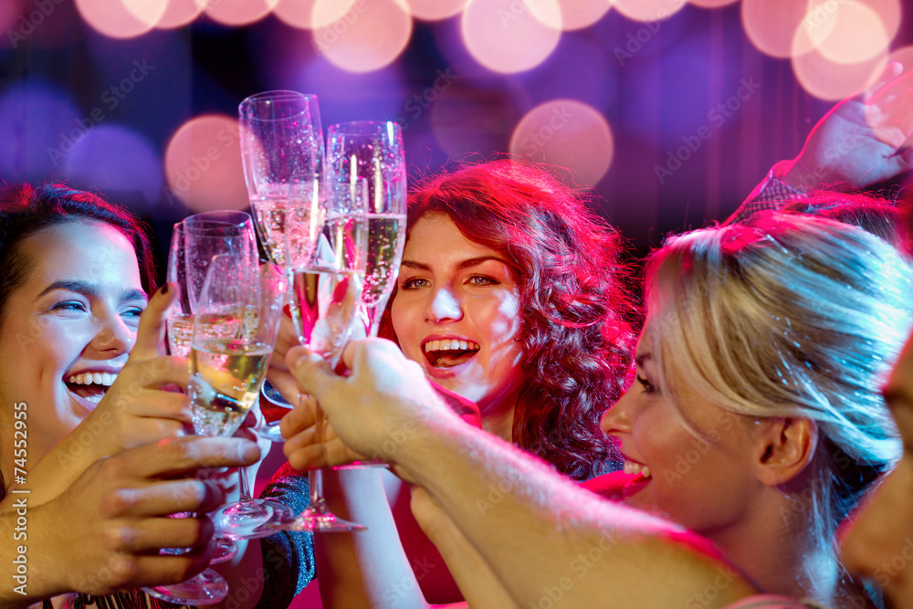 smiling friends with glasses of champagne in club - obrazy, fototapety, plakaty 