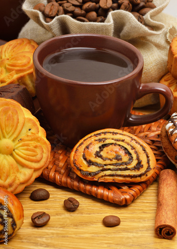 Cup of coffee with biscuits, coffee beans in bags and cinnamon s