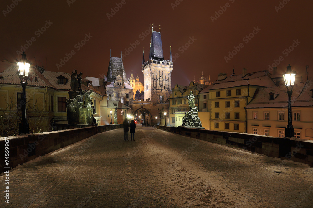 Night colorful snowy Prague gothic Castle from Charles Bridge