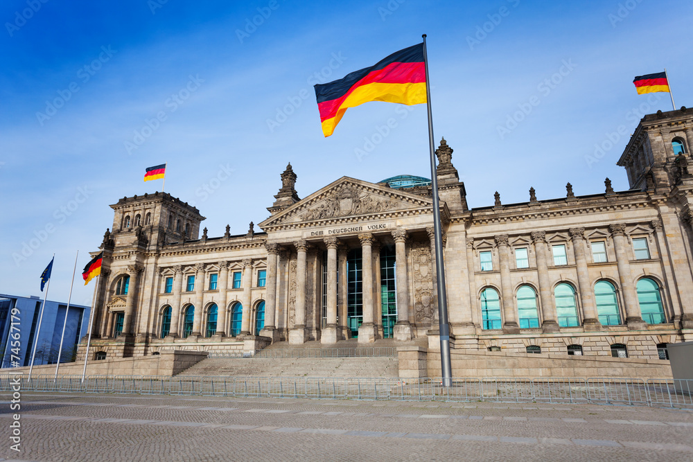 Reichstag facade view with German flags, Berlin