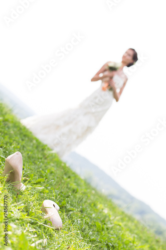Young bride walking on meadow