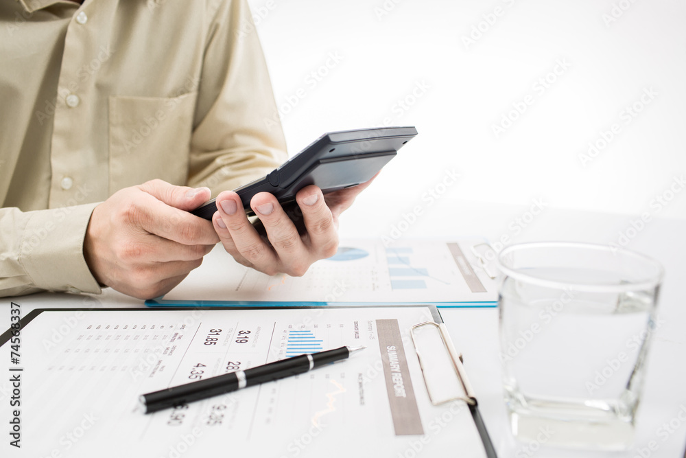 Fototapeta premium Close-up of graphs and charts analyzed by businessman
