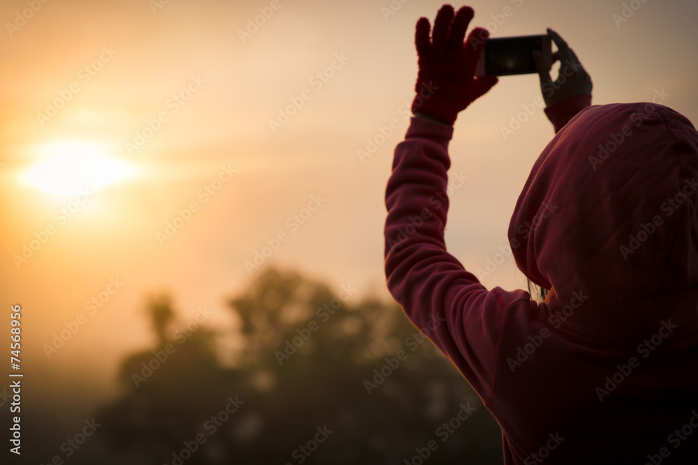 Fototapeta premium woman hiker taking photo with smart phone at mountain peak