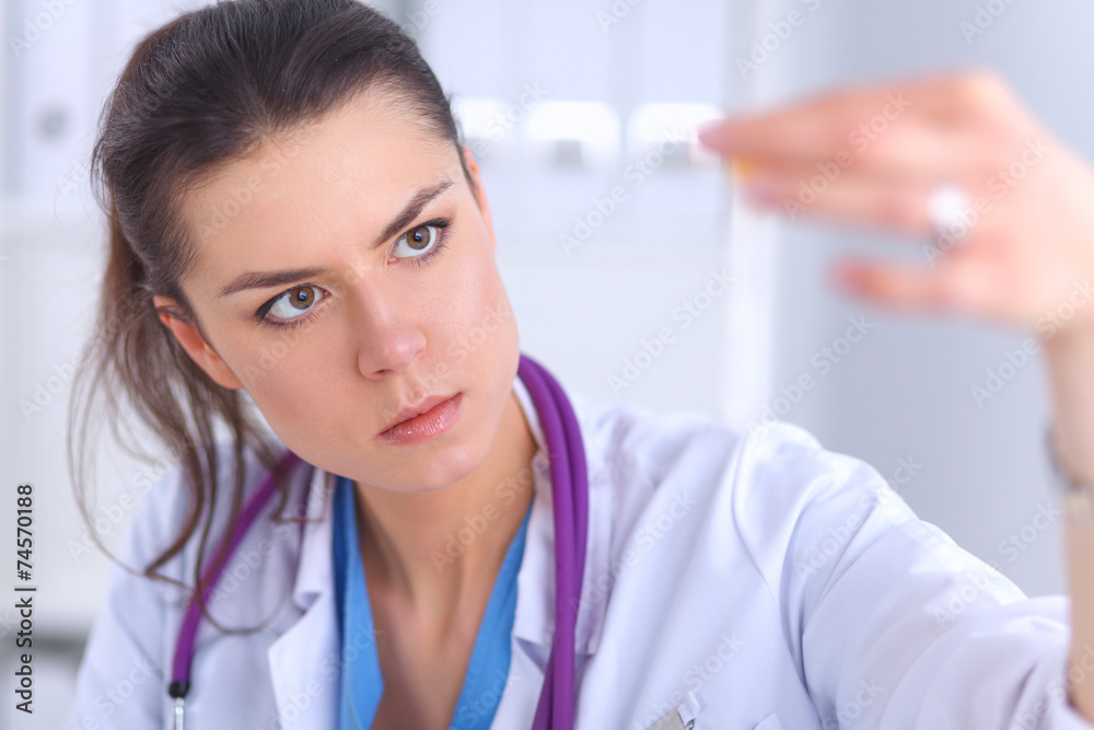 Woman researcher is surrounded by medical vials and flasks, Woman researcher is surrounded by medical vials and flasks,