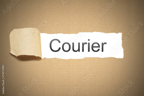 brown paper torn to reveal courier