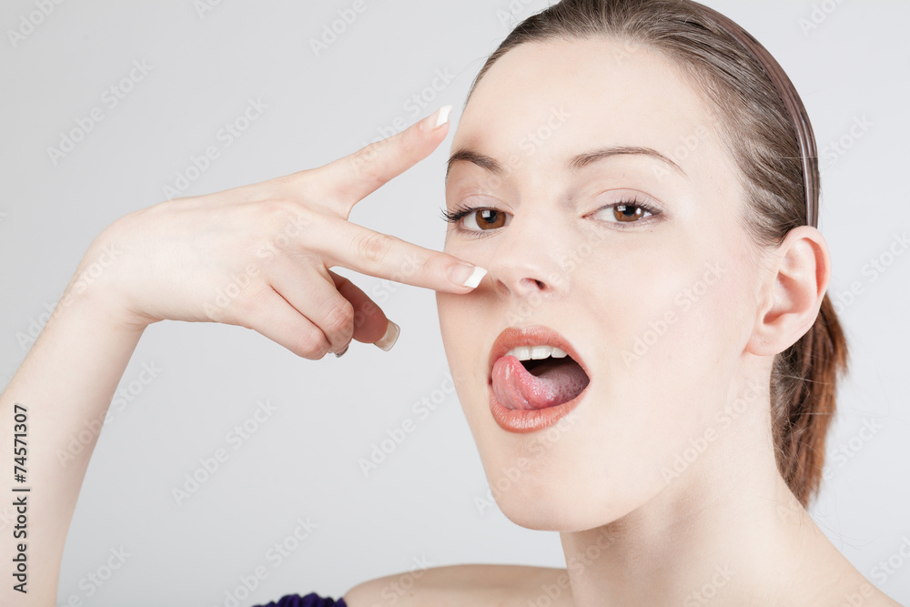 Junge hübsche Frau mit Mimik und Zunge