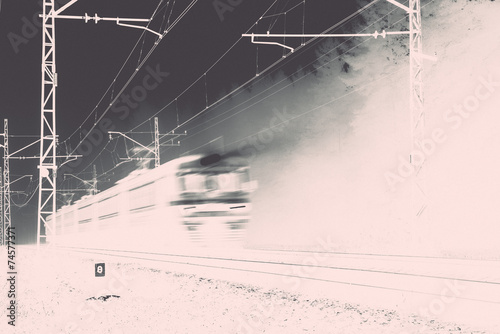 misty country railroad in the early morning with train incoming