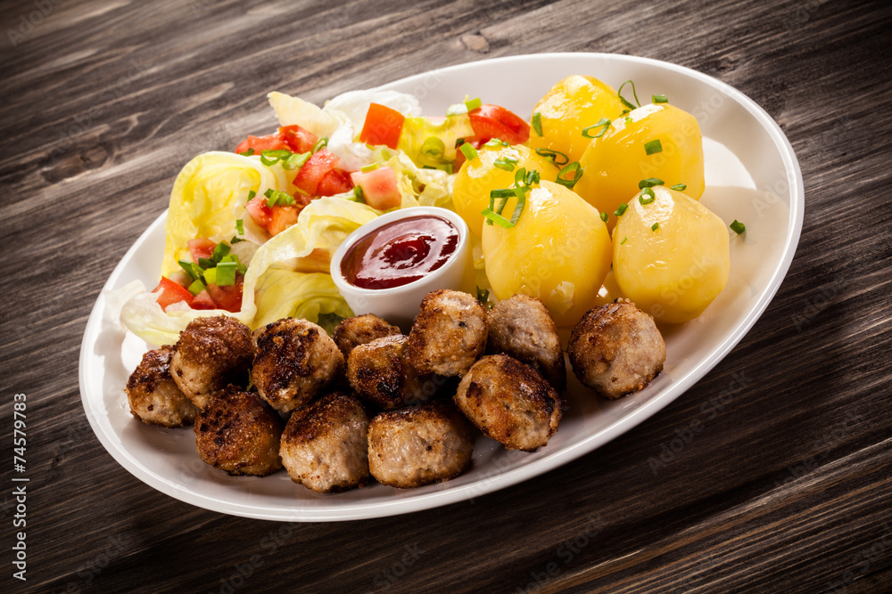 Roast meatballs, French fries and vegetable salad