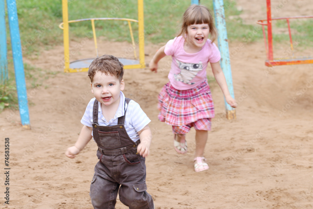 Little Boy in overalls runs away from girl Little Boy in overalls runs away from girl