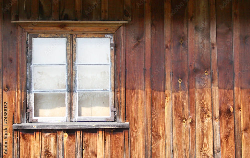 The old window in the wooden gouse wall The old window in the wooden gouse wall