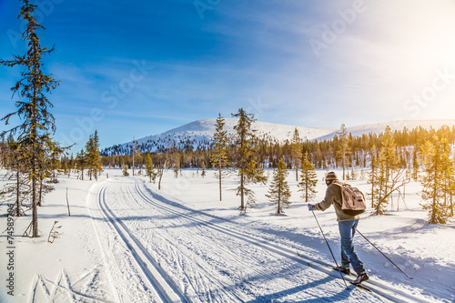 Cross-country skiing in Scandinavian winter landscape at sunset © JFL Photography