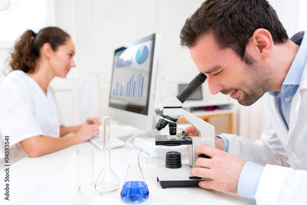 Scientist and her assistant in a laboratory Scientist and her assistant in a laboratory