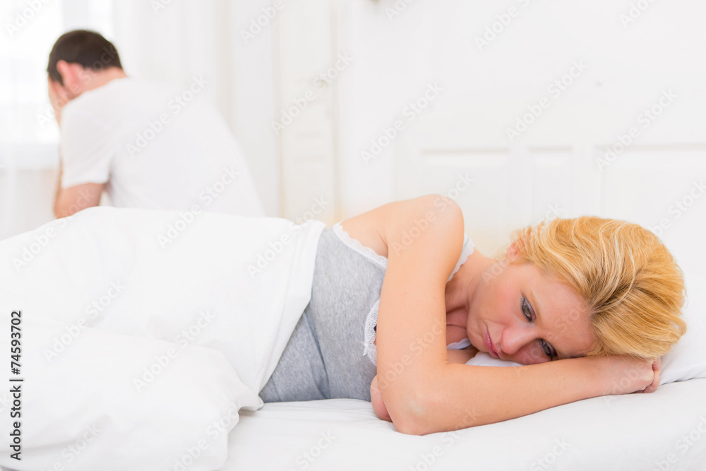 Young attractive couple having an argue in bed Young attractive couple having an argue in bed