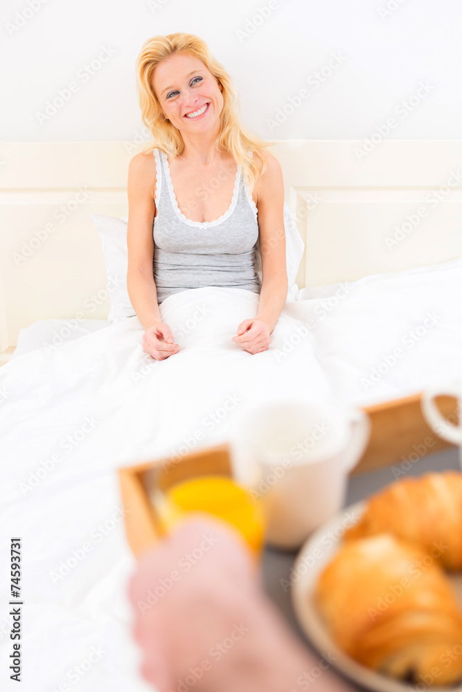 Man bringing young attractive woman breakfast in bed Man bringing young attractive woman breakfast in bed