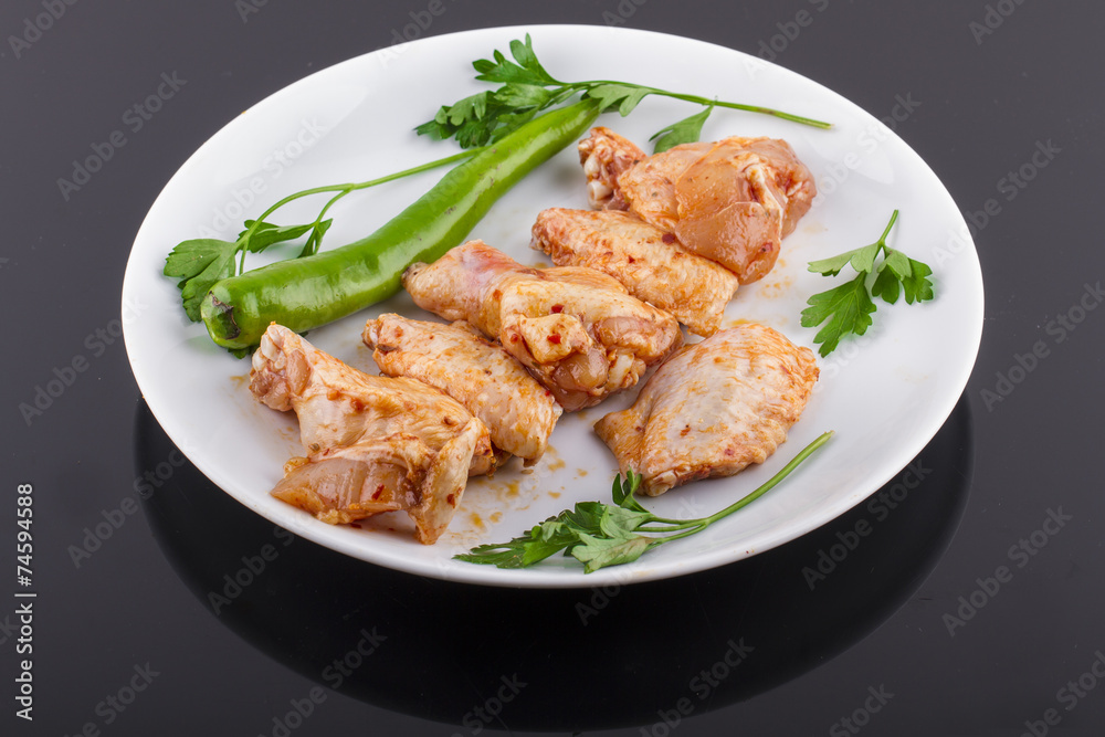 raw chicken legs and chicken wings on a plate raw chicken legs and chicken wings on a plate