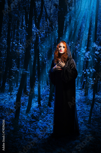 Witch at night forest
