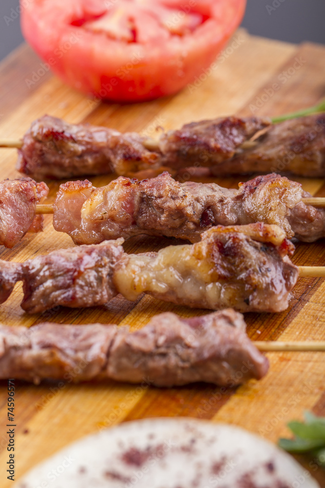 Lamb Skewers on Wooden Plate