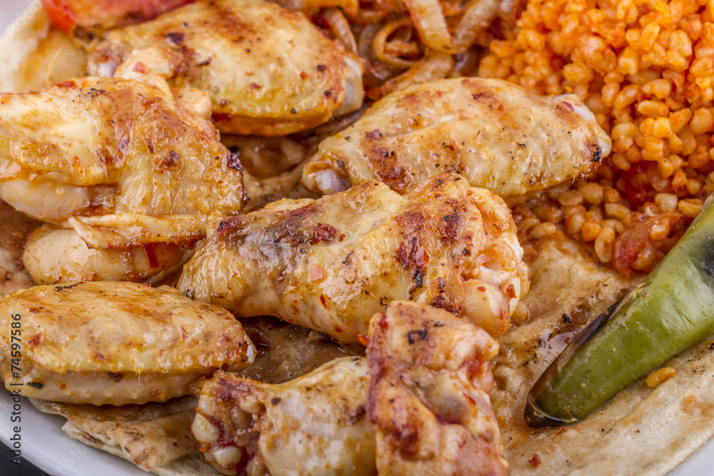 grilled chicken wings and legs on wooden plate grilled chicken wings and legs on wooden plate