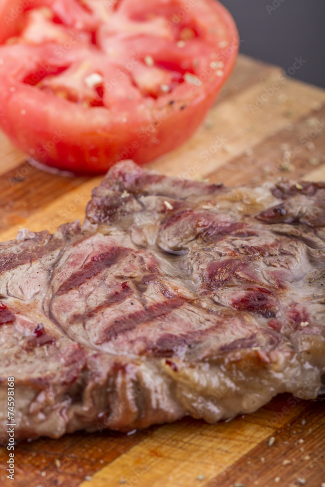 Grilled Steaks and Vegetables On a Wood Plate Grilled Steaks and Vegetables On a Wood Plate